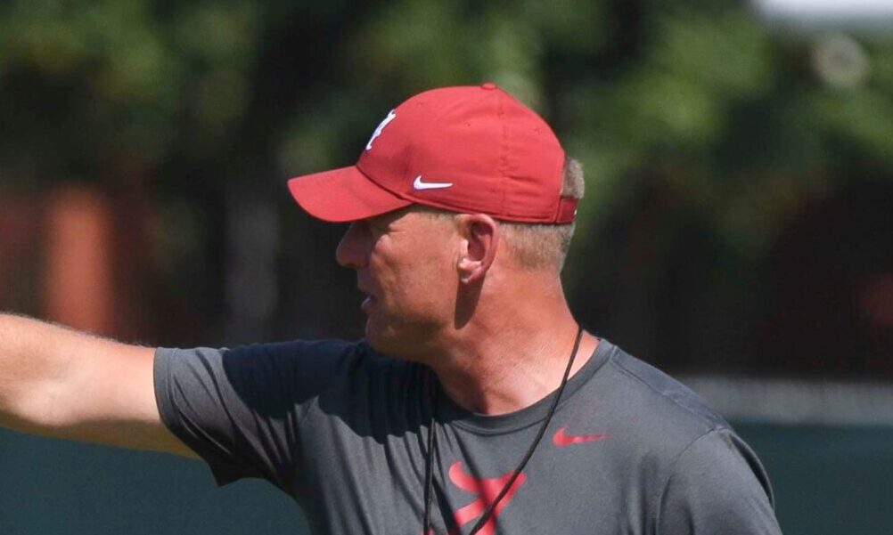 Alabama head coach Kalen DeBoer giving out signals in Sunday's fall camp practice.