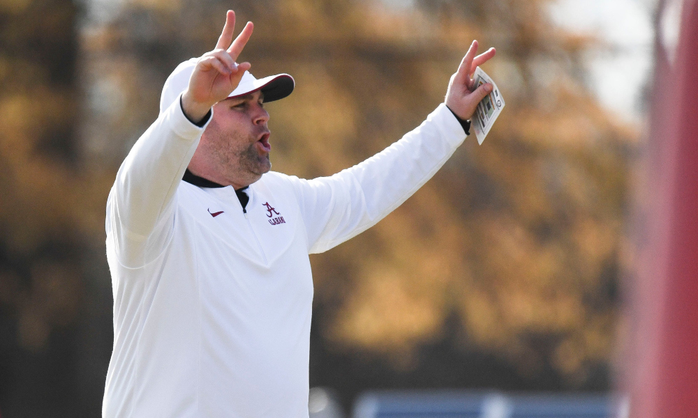 Alabama defensive coordinator Kane Wommack signals to the defense at practice