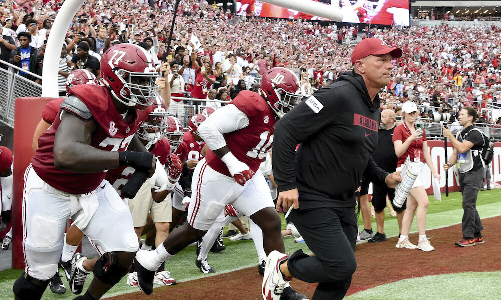 Alabama head coach Kalen DeBoer leads the Crimson Tide out the tunnel onto the field for season opener versus Western Kentucky.