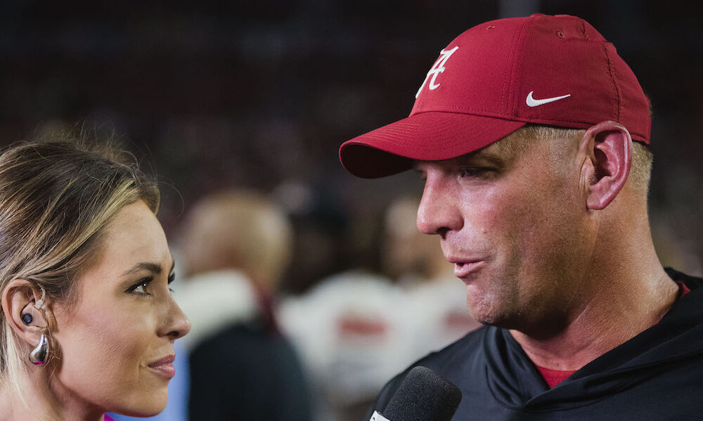 Alabama head coach Kalen DeBoer speaking to a reporter after the Crimson Tide's 2024 win over WKU.