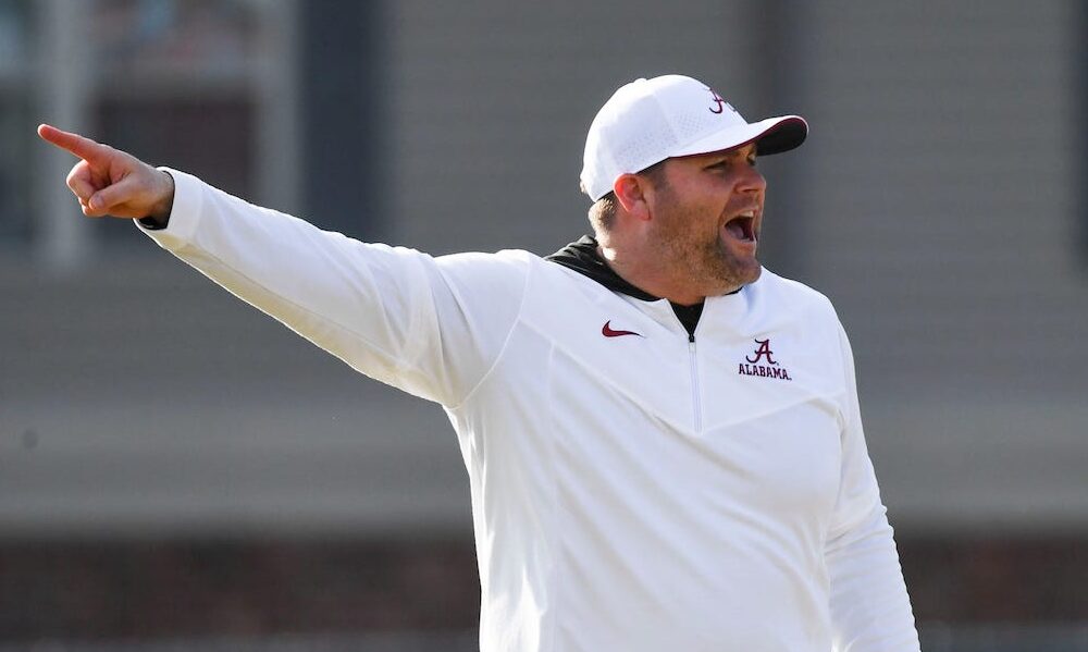 Alabama DC Kane Wommack giving signals to the Crimson Tide's defense in 2024 spring practice.