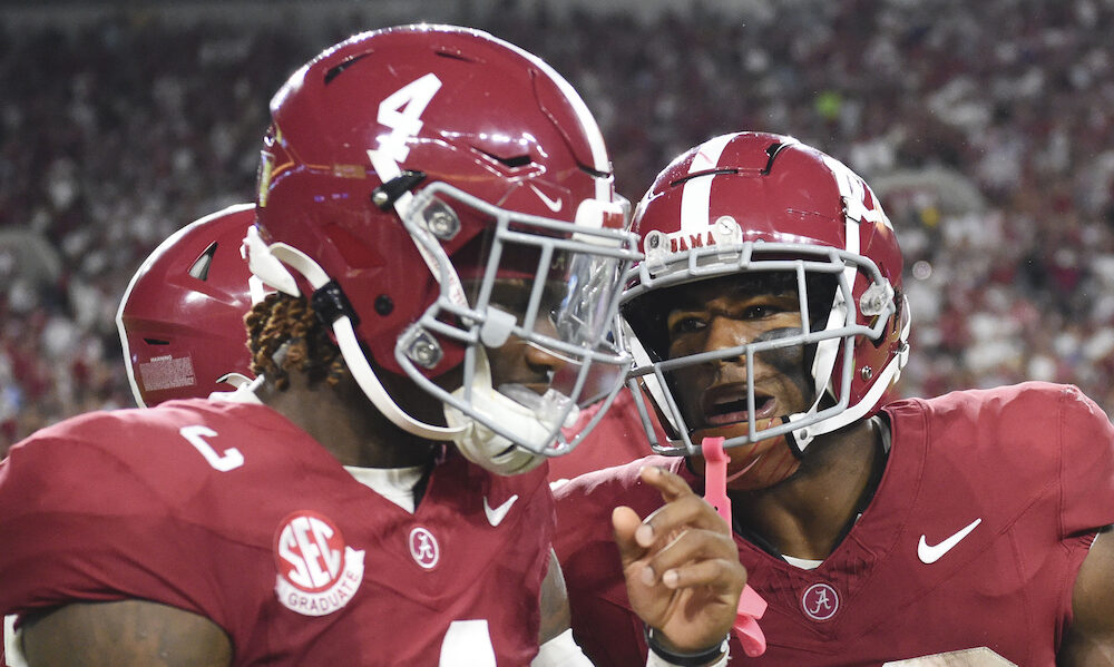 Alabama QB Jalen Milroe (#4) and RB Justice Haynes (#22) walk to Alabama's sideline after Haynes scores a touchdown versus WKU.