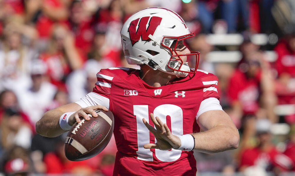 Wisconsin QB Tyler Van Dyke (#10) attempting a pass versus South Dakota in 2024 matchup.