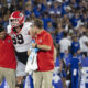 Georgia OL Tate Ratledge (#69) helped off the field after suffering an ankle injury against Kentucky in 2024 matchup.