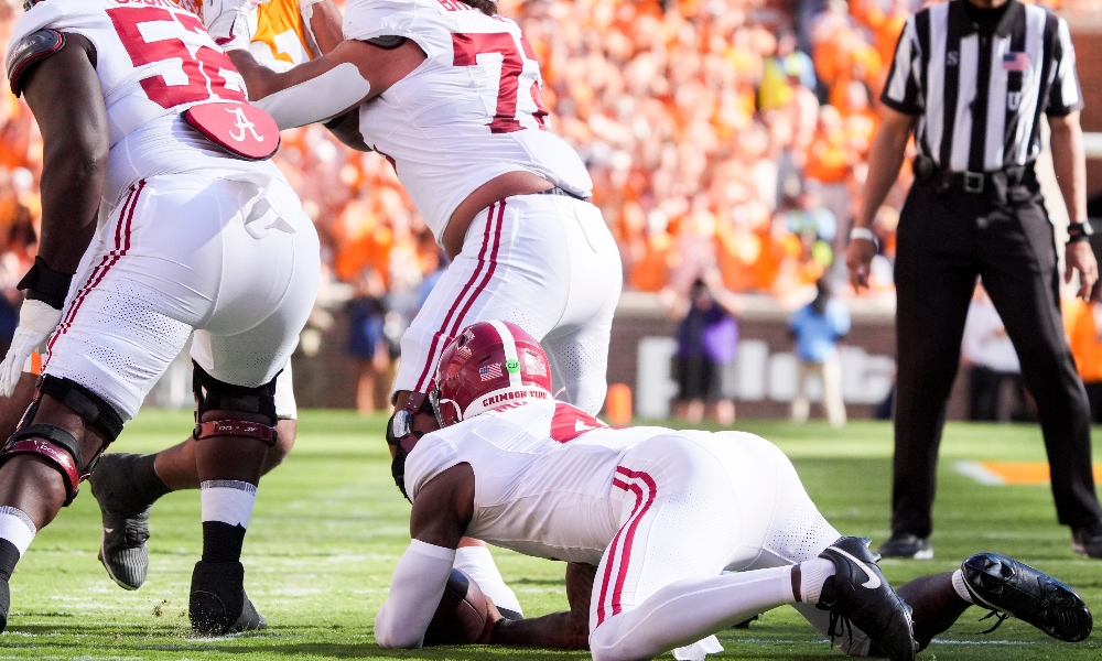 Alabama quarterback Jalen Milroe falls on a botched snap against Tennessee