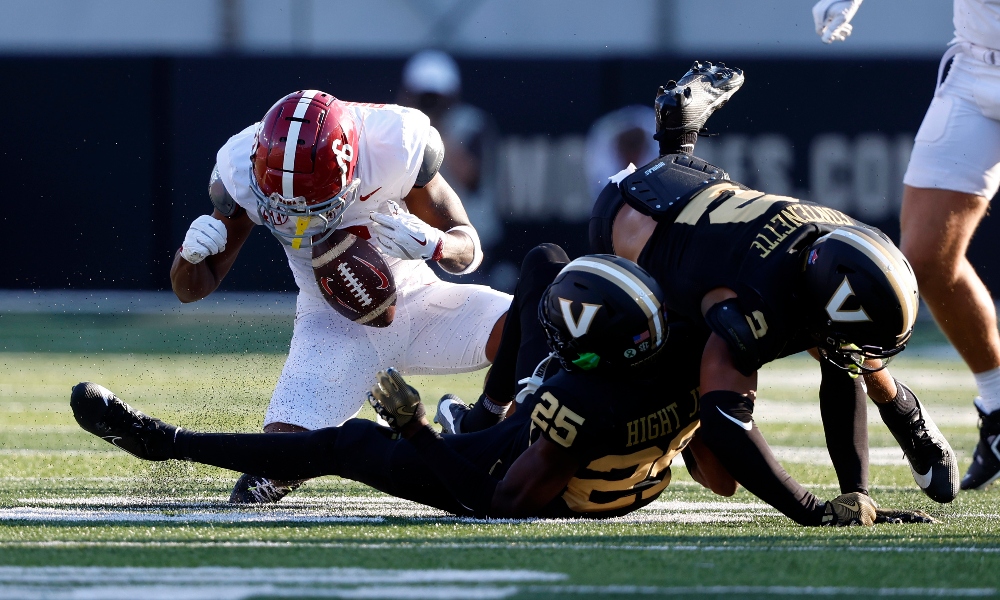 Alabama Crimson Tide wide receiver Kobe Prentice (6) drops the ball after being tackled by Vanderbilt Commodores cornerback Martel Hight (25) and linebacker Randon Fontenette (2) during the first half at FirstBank Stadium.