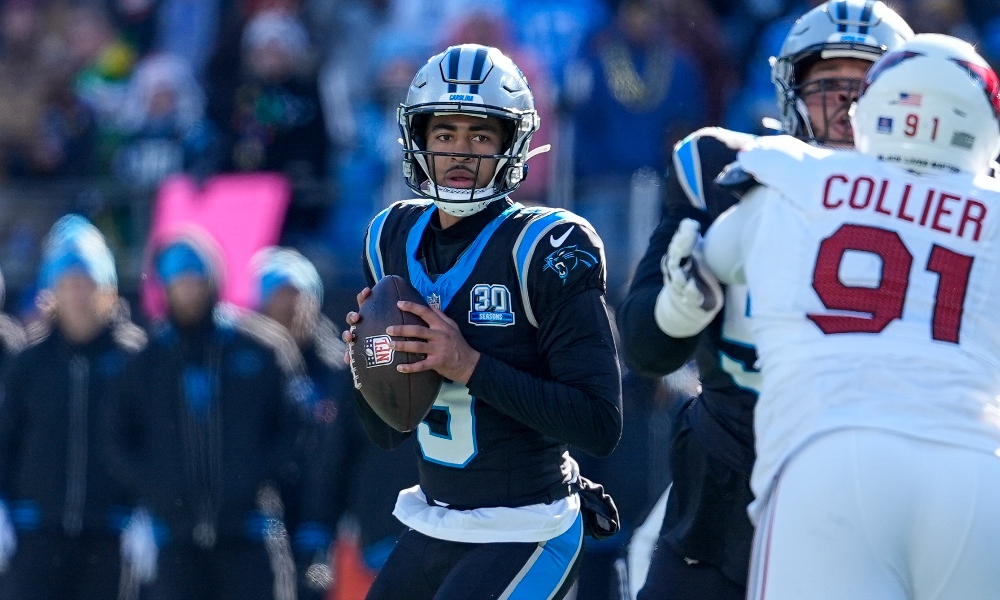 Dec 22, 2024; Charlotte, North Carolina, USA; Carolina Panthers quarterback Bryce Young (9) looks for a receiver against the Arizona Cardinals during the second quarter at Bank of America Stadium.