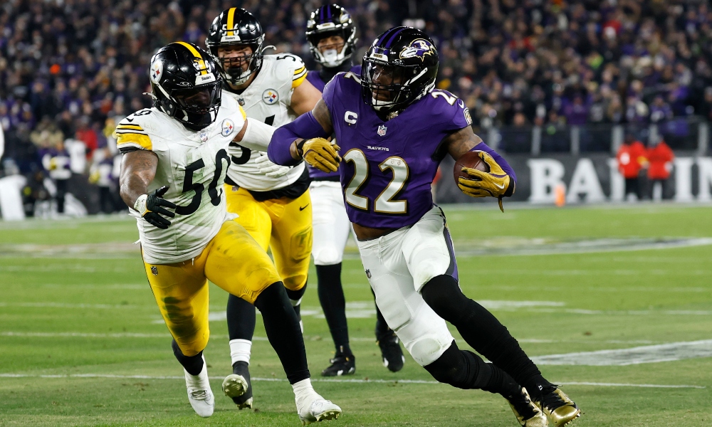 Jan 11, 2025; Baltimore, Maryland, USA; Baltimore Ravens running back Derrick Henry (22) runs against Pittsburgh Steelers linebacker Elandon Roberts (50) in the second quarter in an AFC wild card game at M&T Bank Stadium.