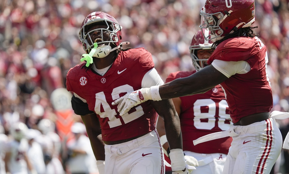 Alabama LB Yhonzae Pierre (#42) celebrates a huge play with his teammates in 2025 versus Wisconsin.
