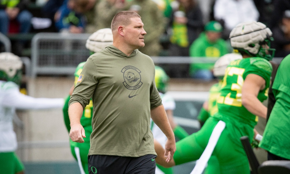 Oregon defensive coordinator Tosh Lupoi watches on during warmups