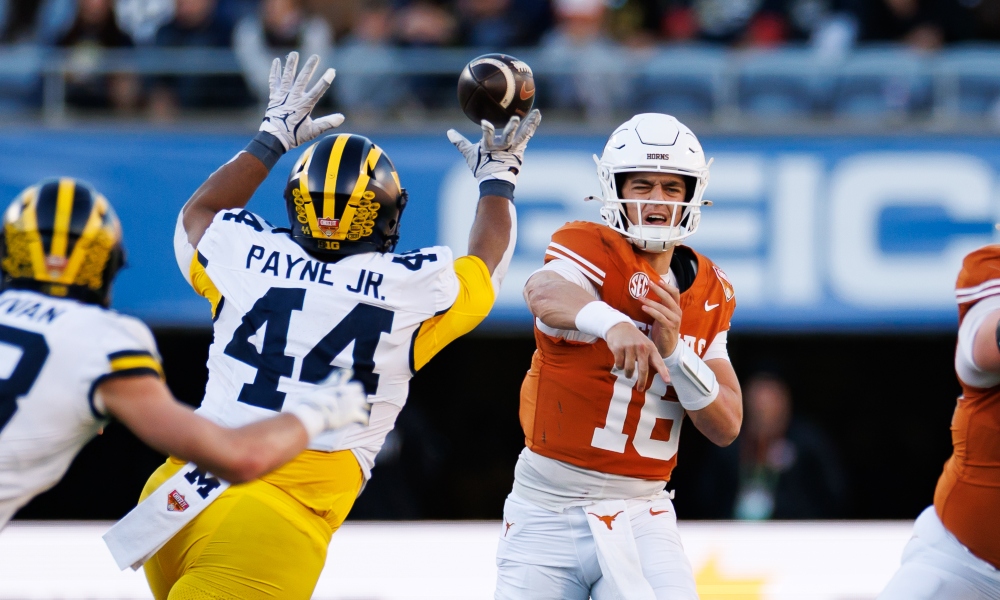 Dec 31, 2025; Orlando, FL, USA; Michigan Wolverines defensive lineman Damon Payne (44) tips a pass from Texas Longhorns quarterback Arch Manning (16) during the first half at Camping World Stadium.