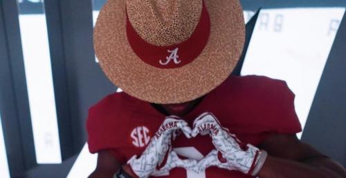 Caleb downs with alabama hat on during official visit