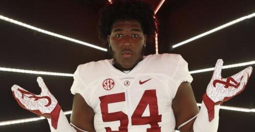Alabama commit, Tyler Booker stands with shock face during alabama visit